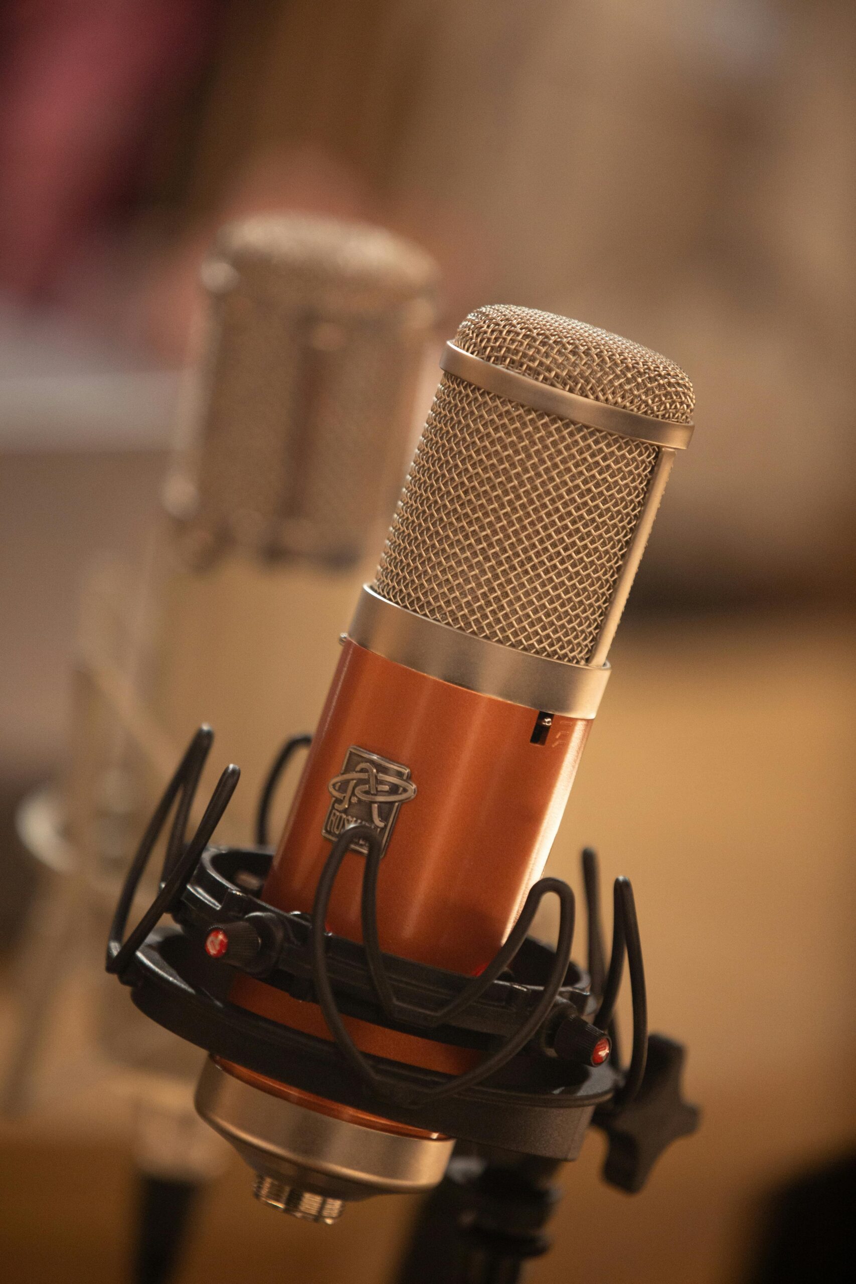 Detailed close-up of a modern studio microphone suitable for audio recording.